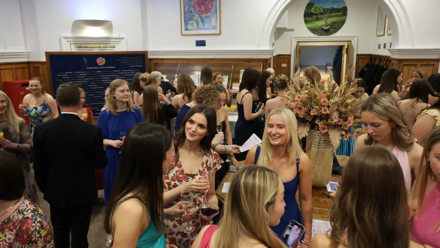 A crowded room of people chatting at the 2026 Longfield Dinner.