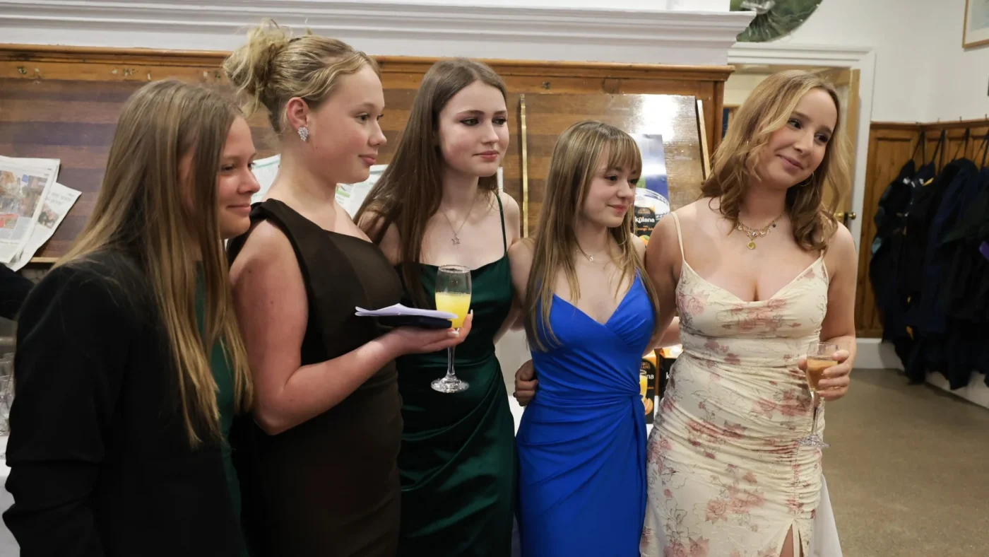Longfield Girls’ Boarding House members celebrating together in dresses.