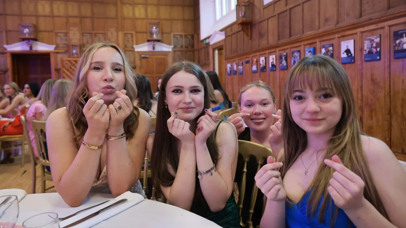A group of Longfield Girls’ Boarding House members doing finger hearts at the Longfield Dinner.