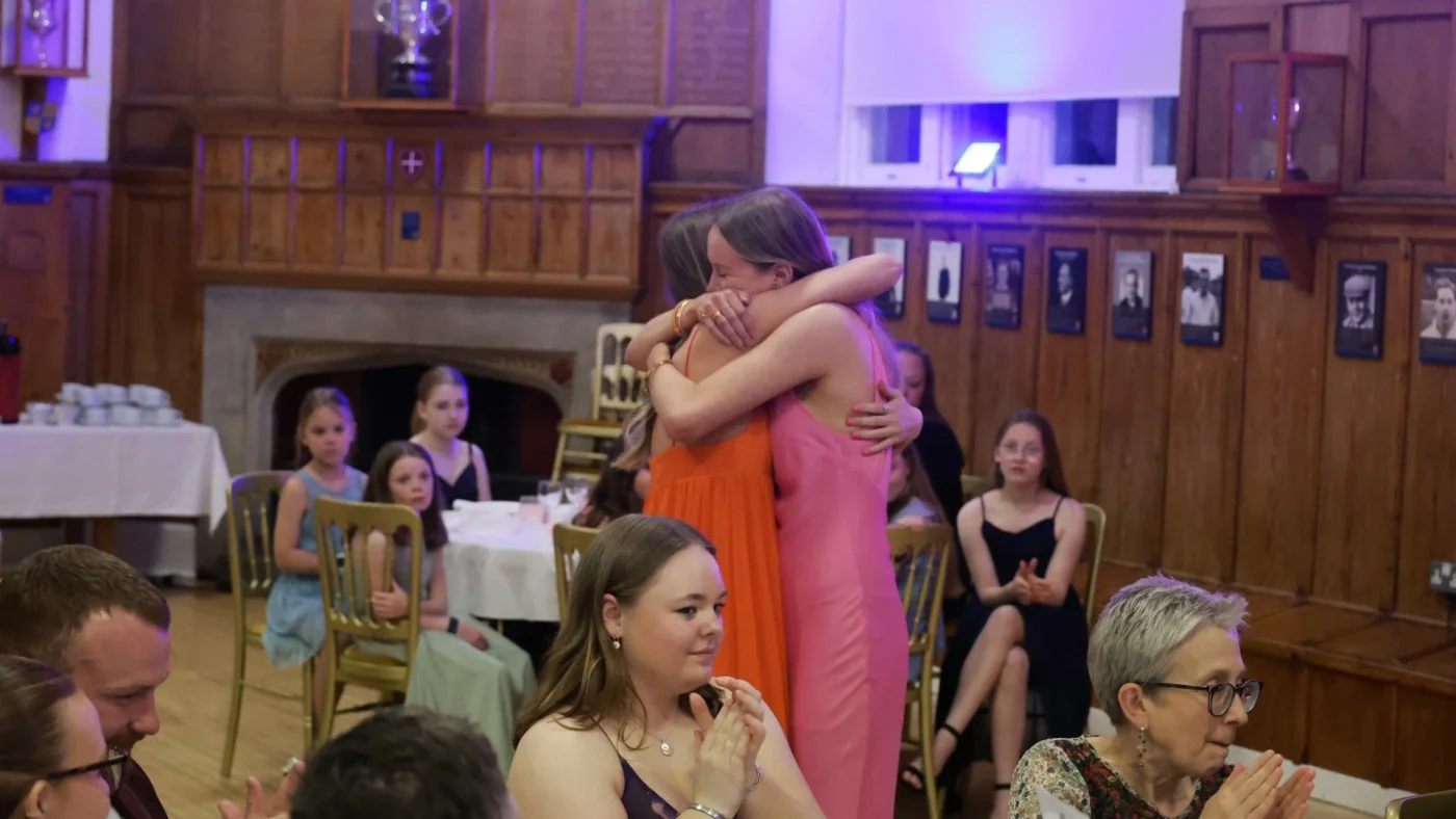 Two Longfield Girls’ Boarding House members hugging at the 2026 Longfield Dinner.