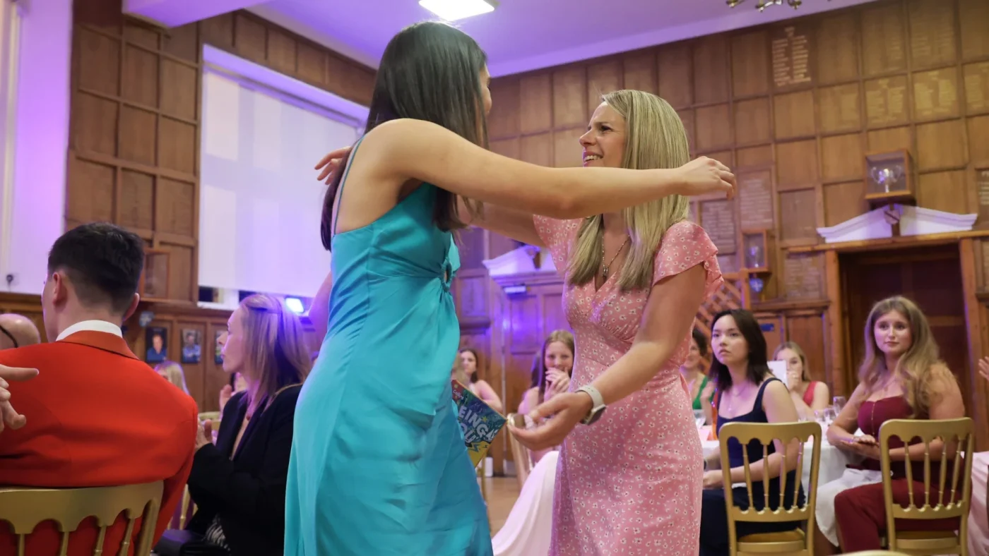 A Barney student and staff member hug at the 2026 Longfield Dinner.
