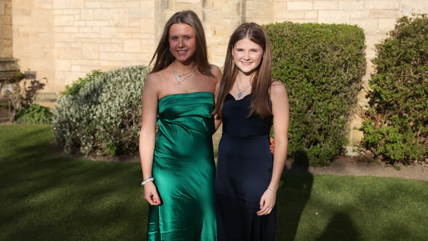 Longfield Girls’ Boarding House members outside in dresses.