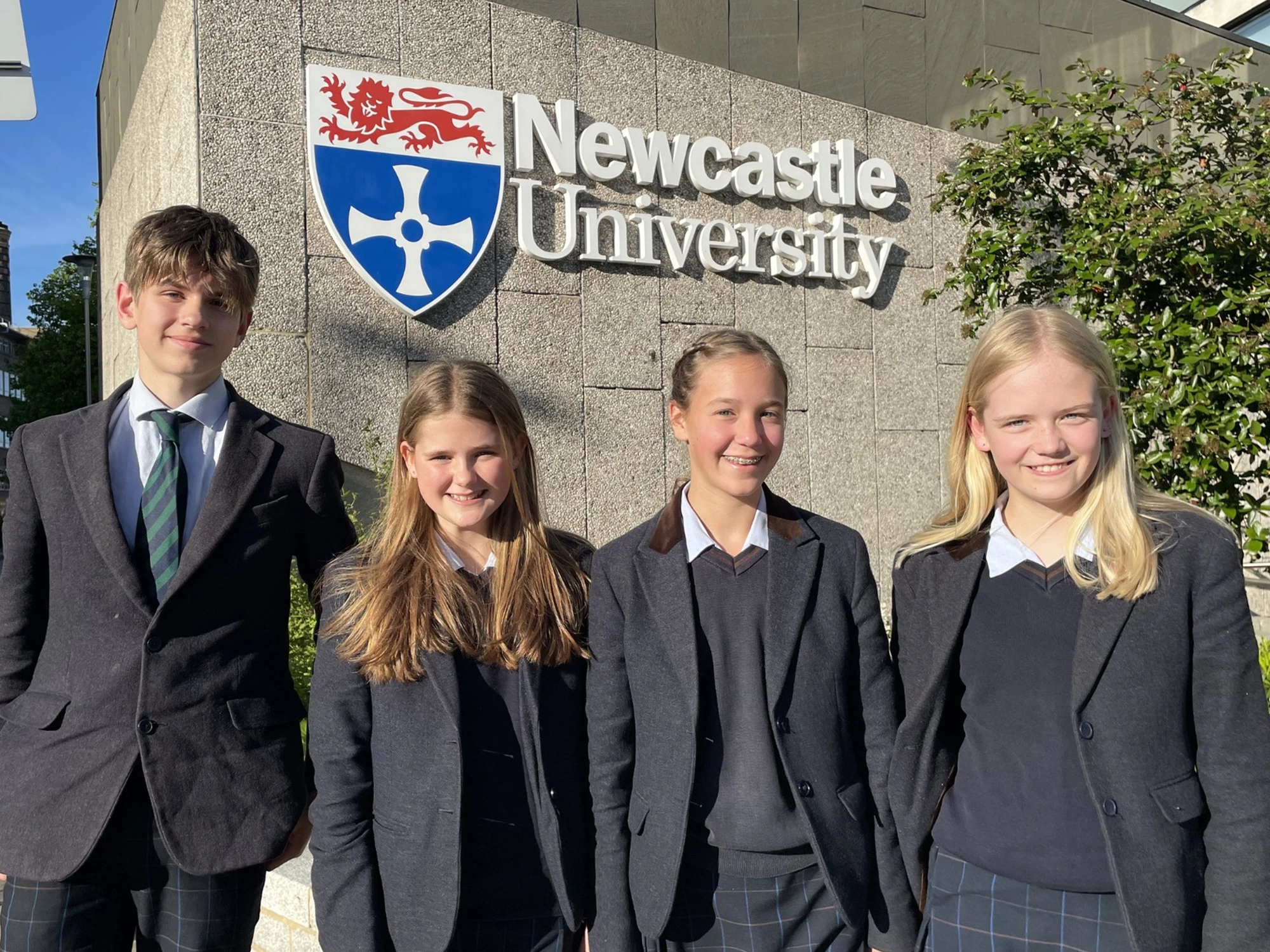 Four Barney pupils stood outside Newcastle University building.