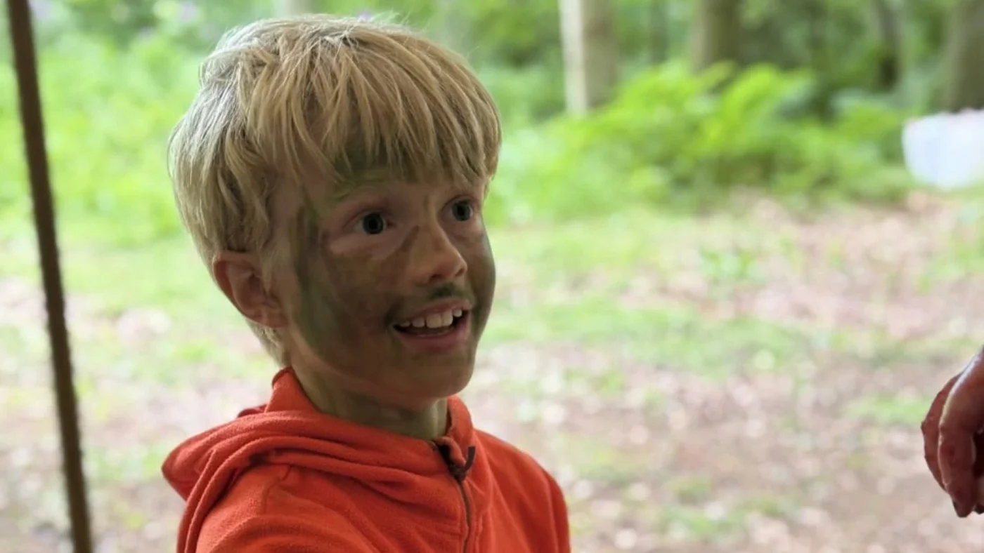 A Barney Year 5 student with green camo face paint on.