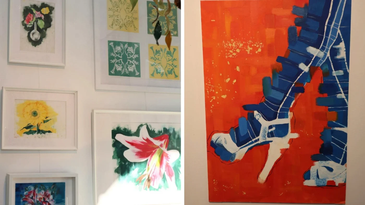 Various paintings of flowers and a pair of legs in heels.