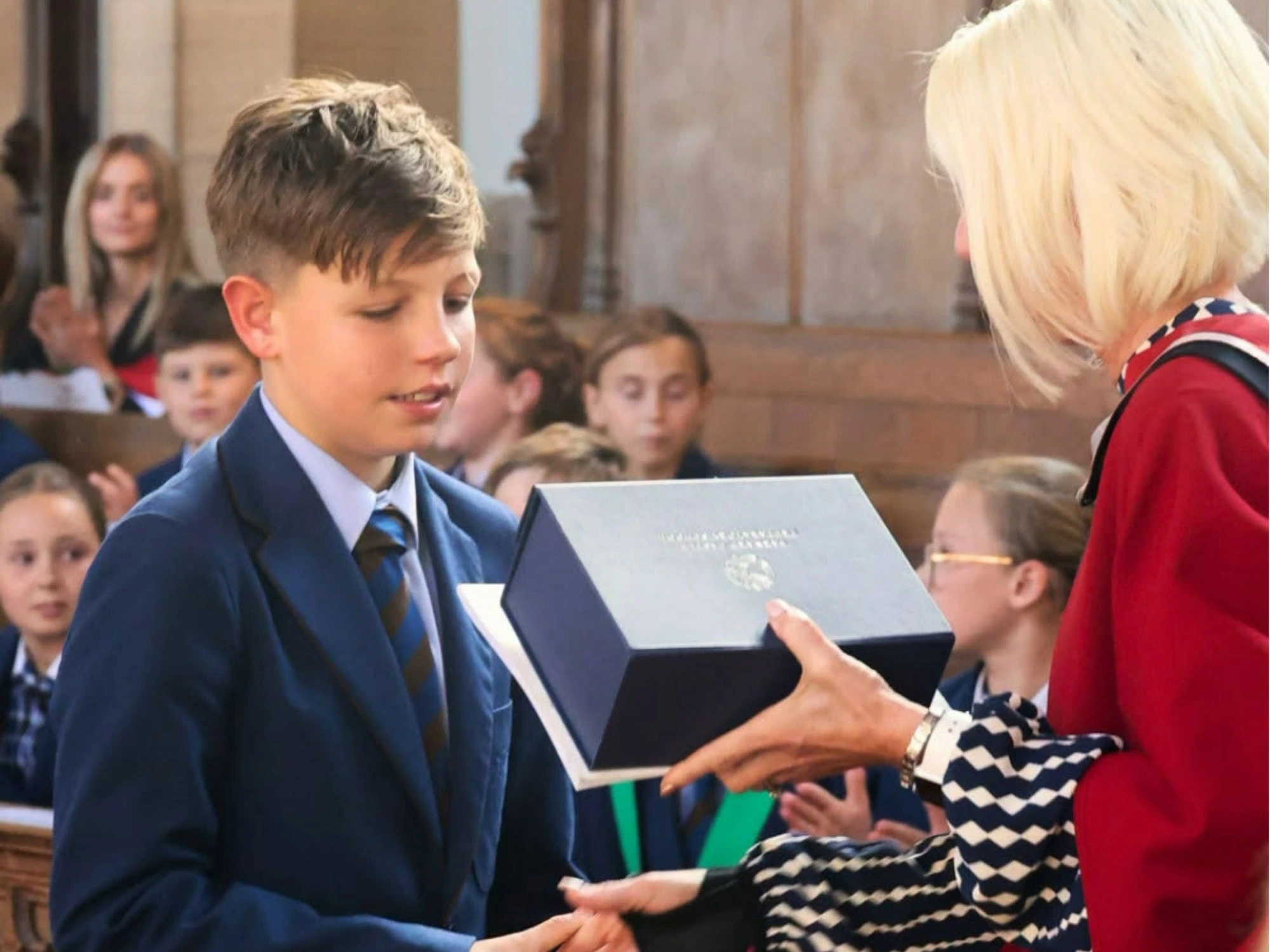 Year 6 student receives blue box at valedictory Service.