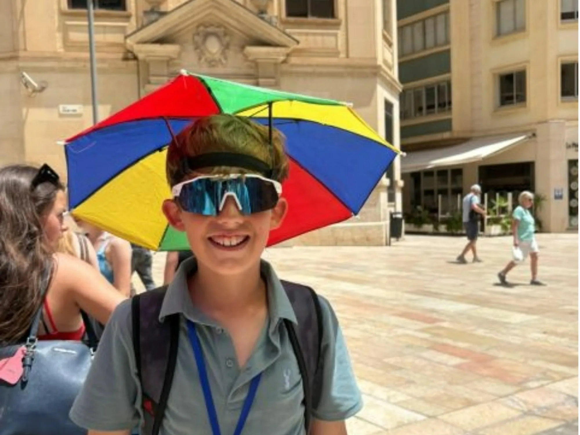 A Barney student sporting an umbrella hat for shade in the streets of Andalusia.