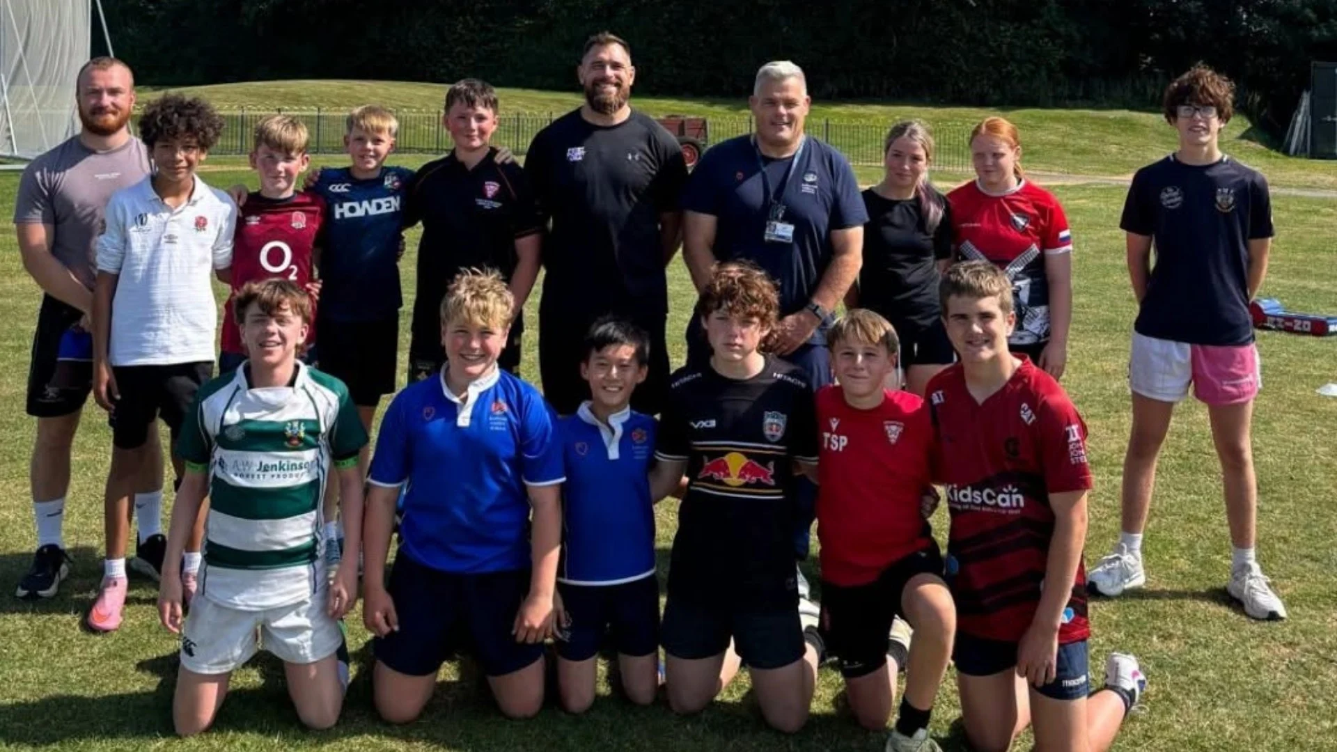 Players and coaches standing together for Barney Rugby Academy.