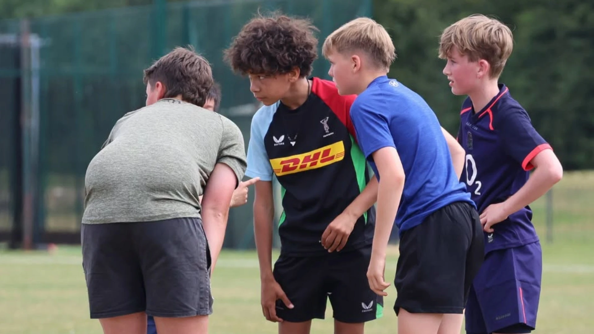 Students huddling during this summer's Barney Rugby Academy.