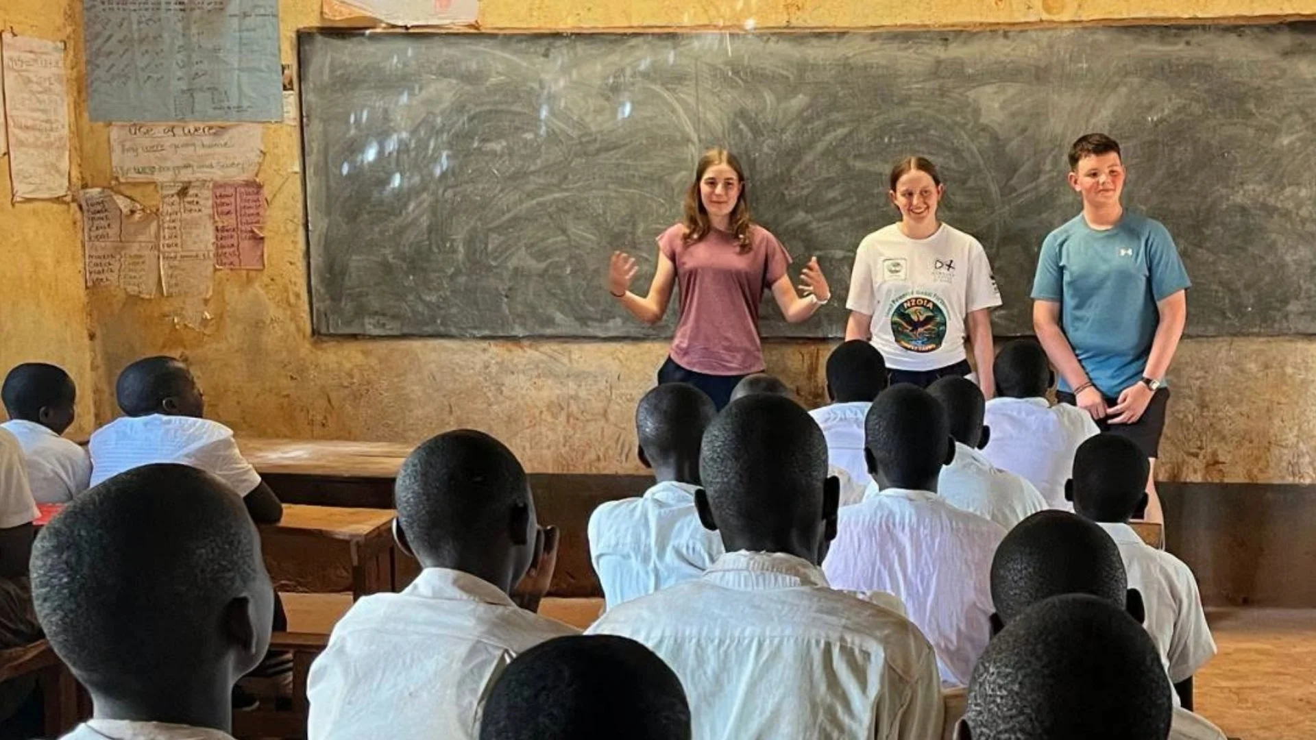 Barney students in front of a blackboard in a classroom in Kenya.