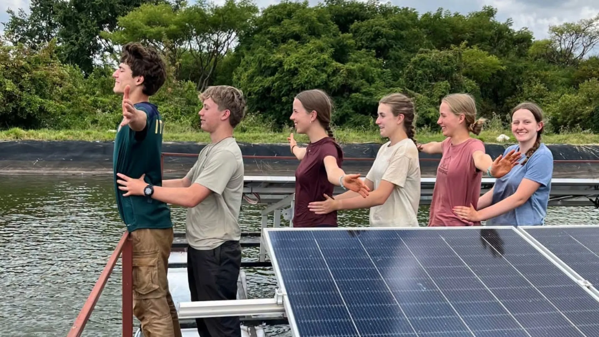 Barney students standing in front of a lake in Kenya.