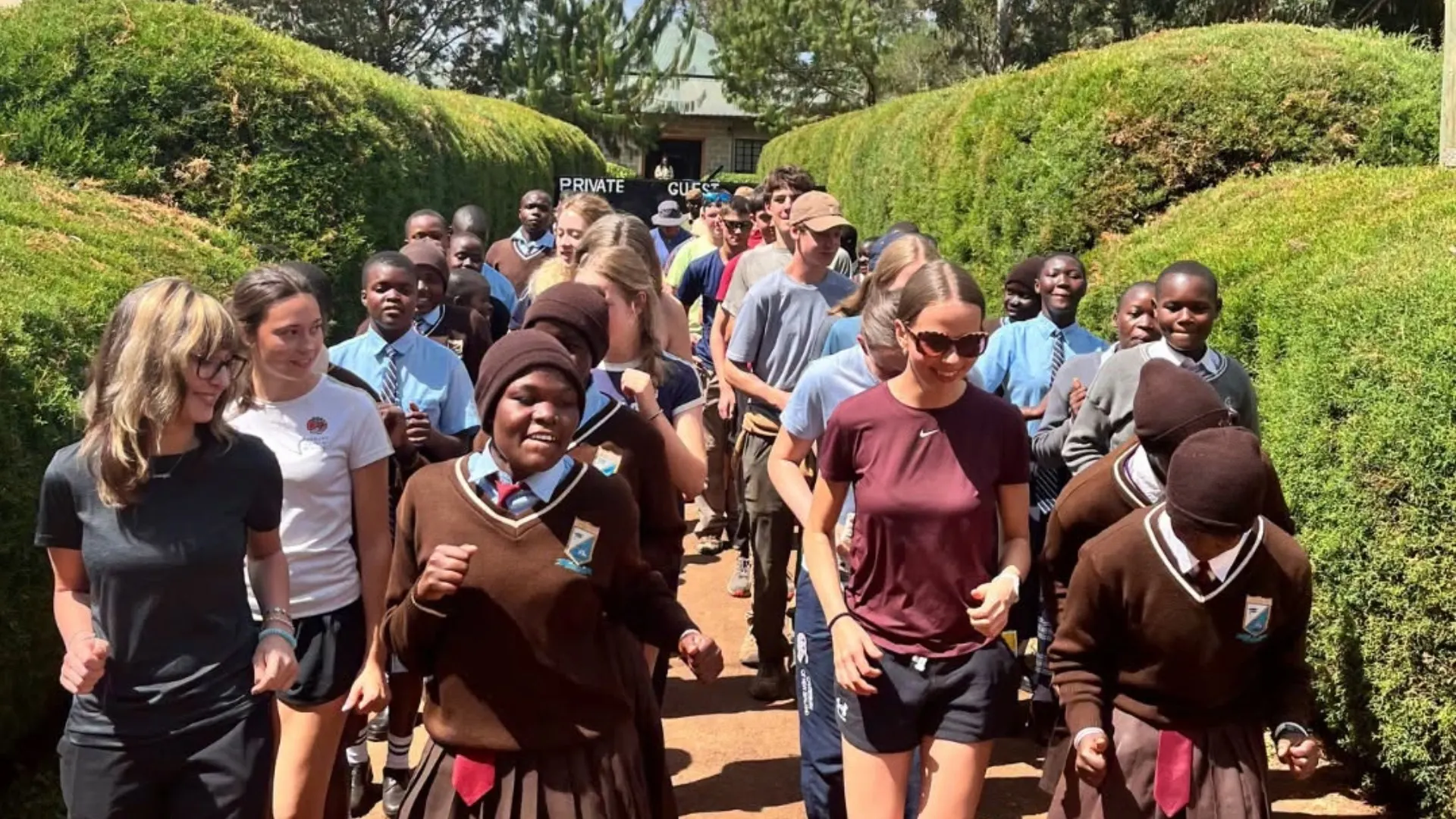 Barney students and locals walk together in Kenya.