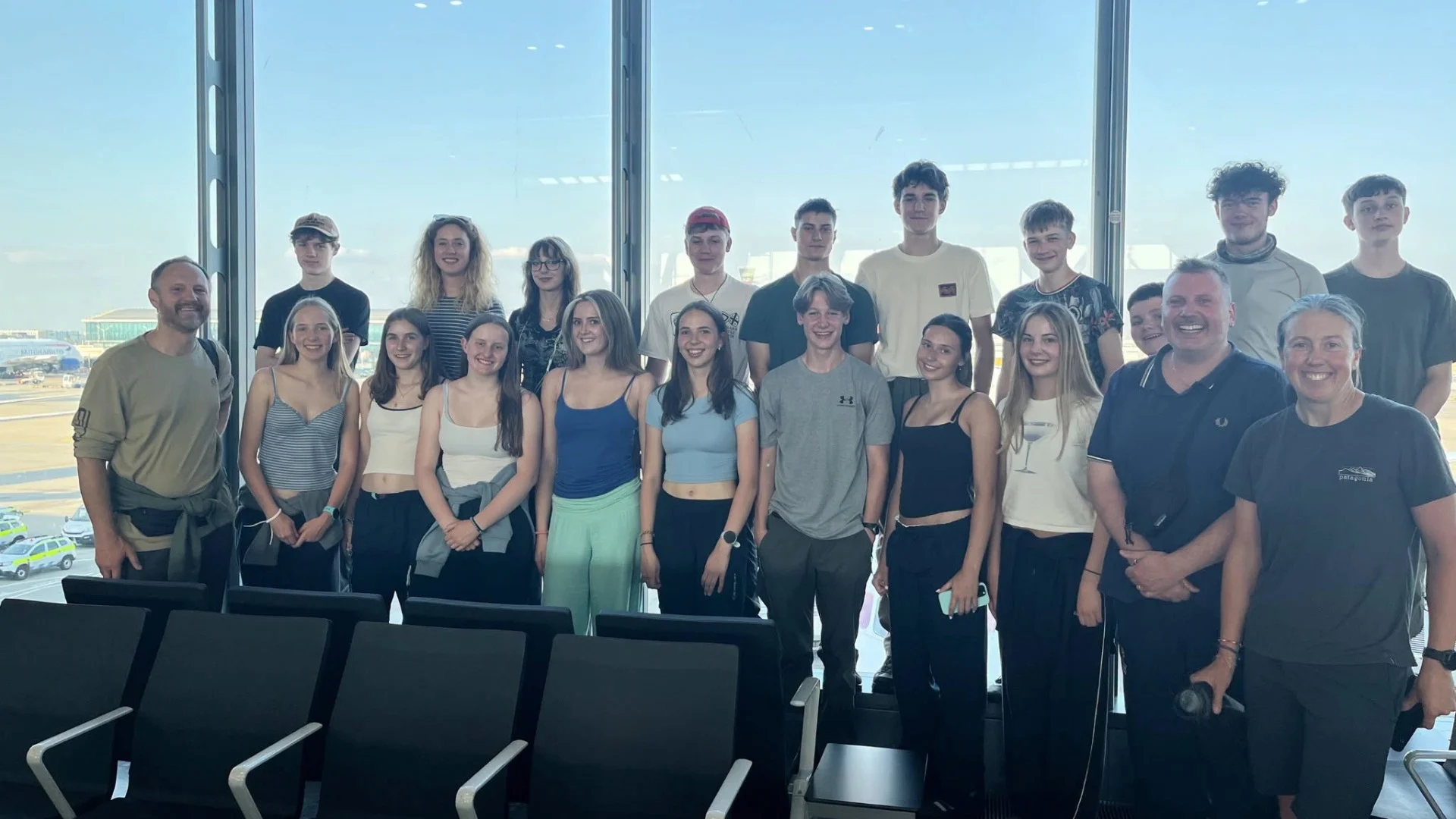 A large group of Barney students at the airport.