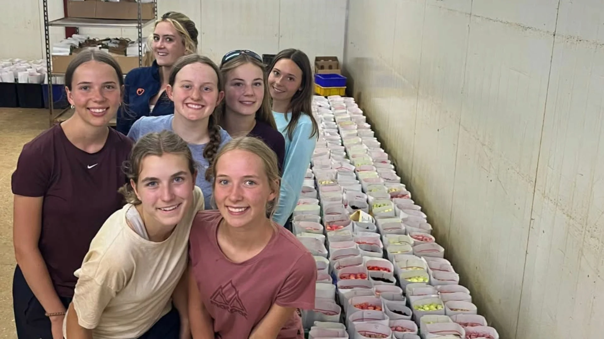 Barney students with containers of food in Kenya.