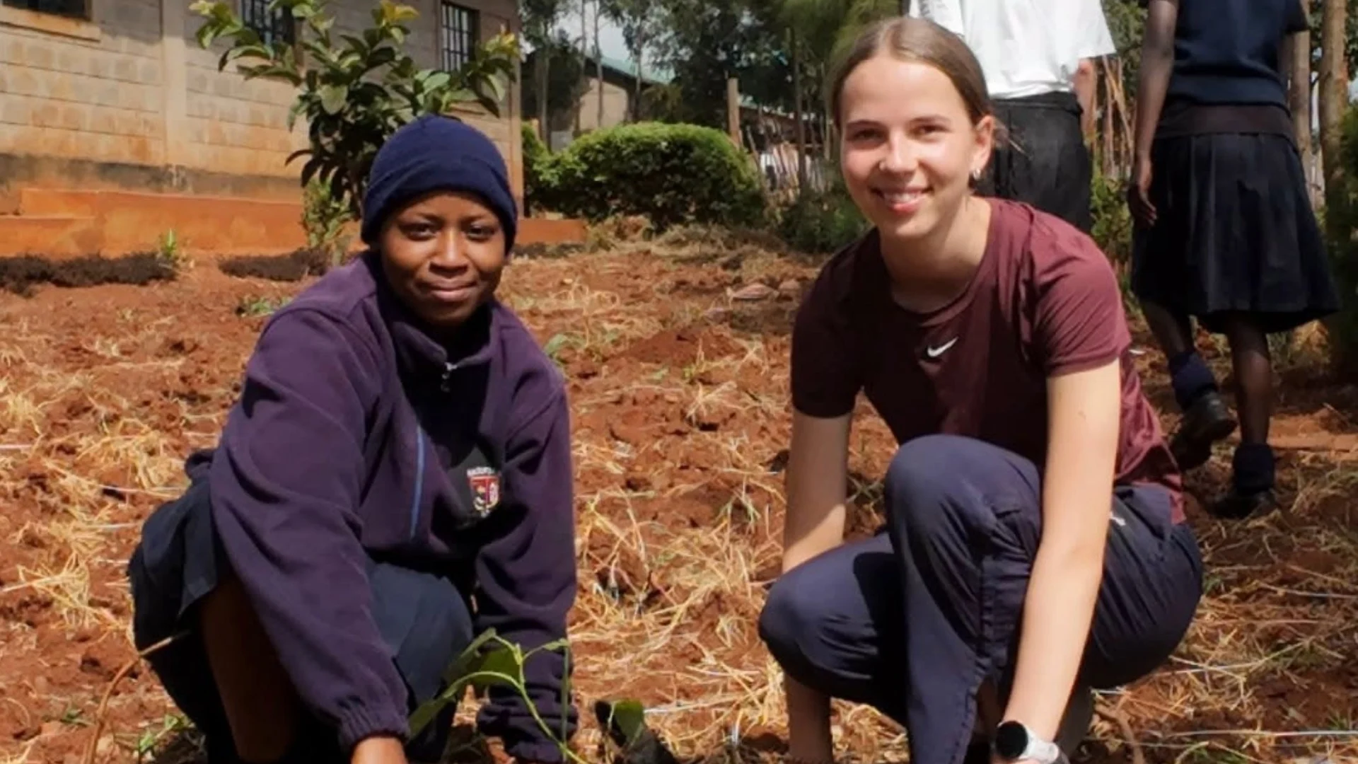 A Barney student with a local girl on the Kenya expedition.