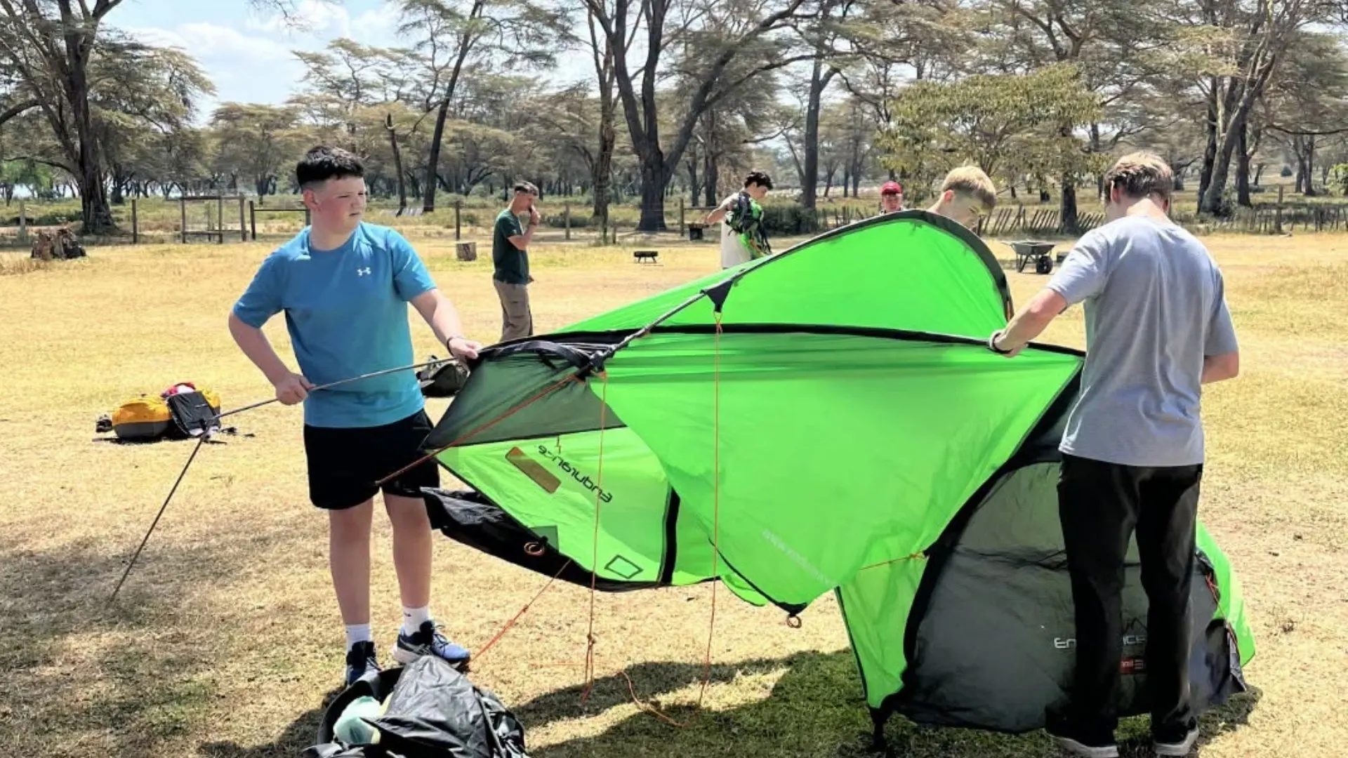 Barney students putting up a tent in Kenya.