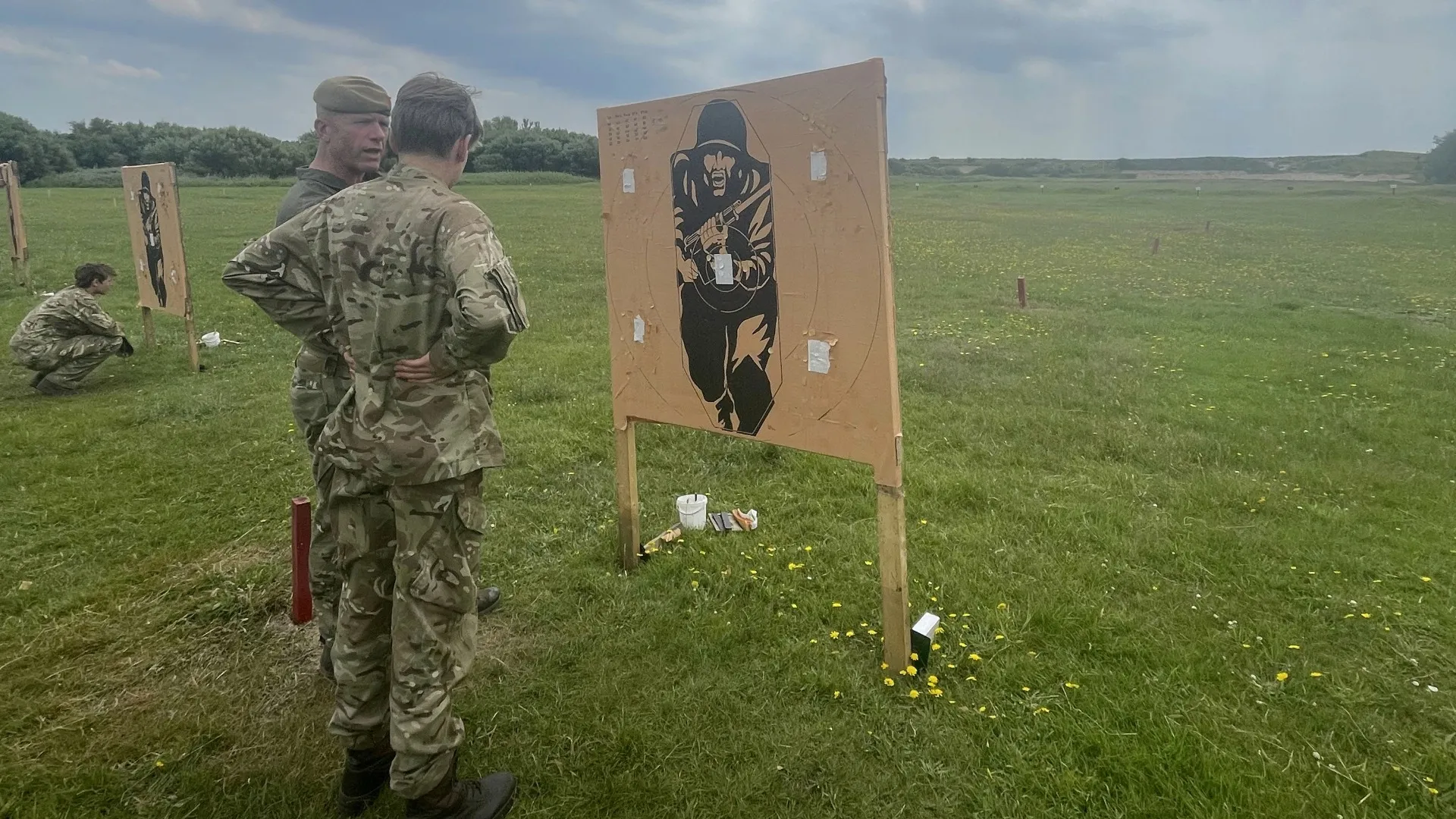 A Barney CCF cadet standing next to a target board.