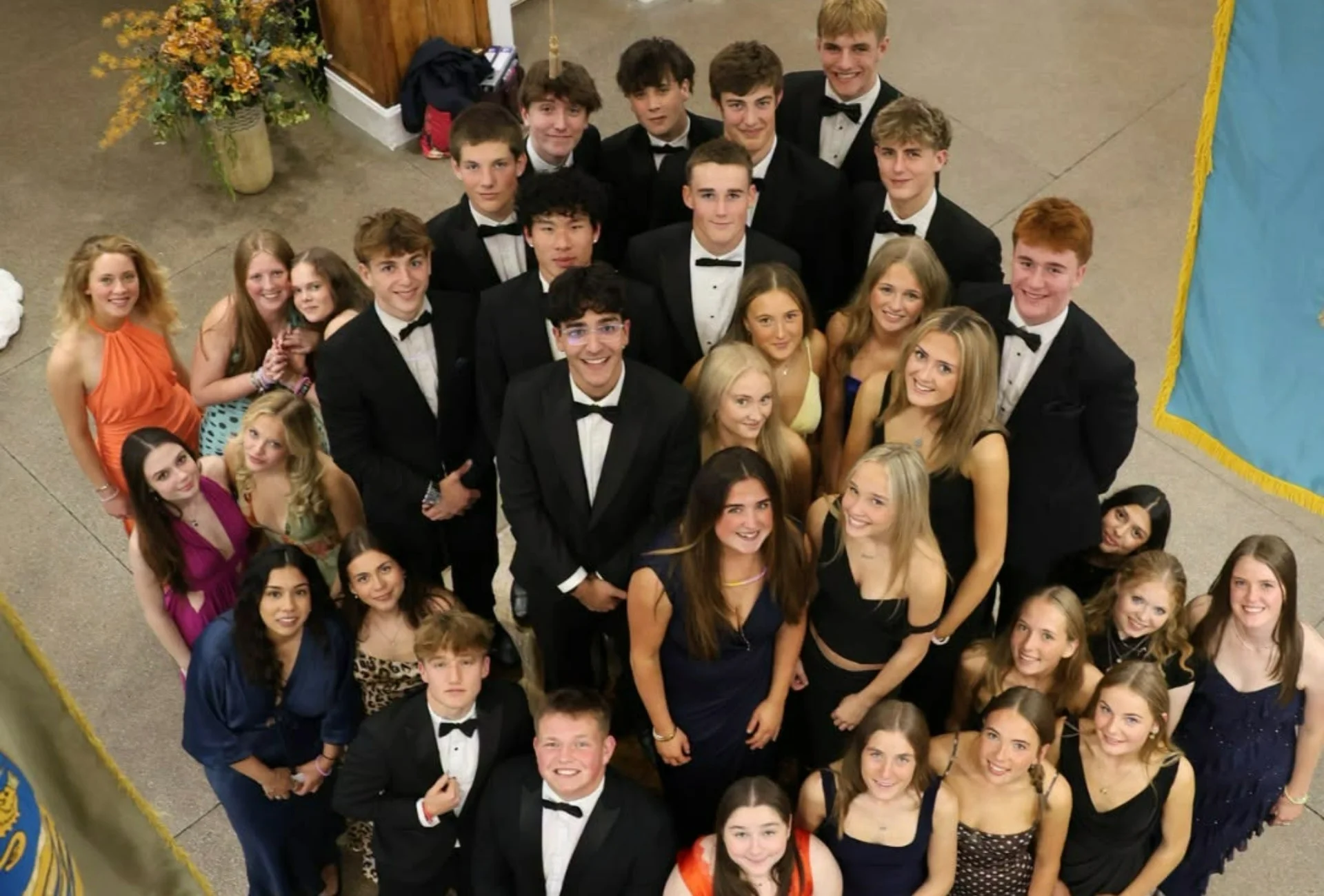 Barnard Castle School's Lectern Club huddled together, smiling.