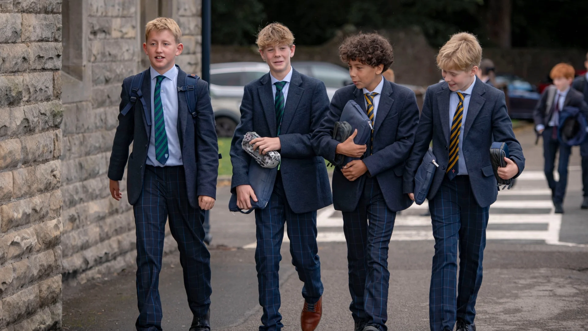 Barney boys walk together and talk.