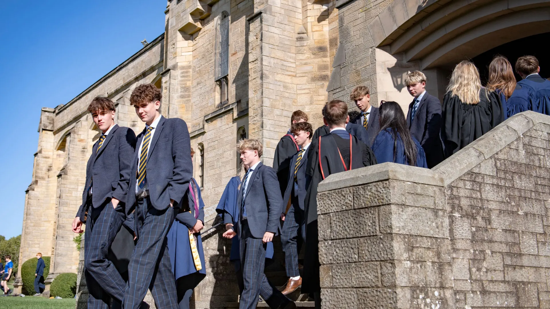 Barney students walking out of the chapel on a clear day.